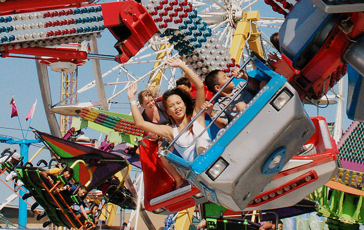 young riders on a midway ride