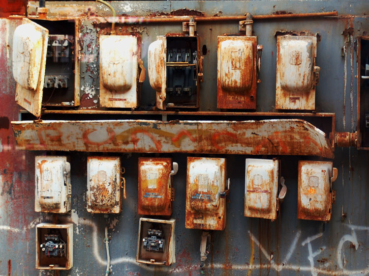 a wall of old, no longer used, circuit breakers