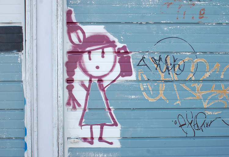 graffiti of a girl with a can of spray paint in her hand