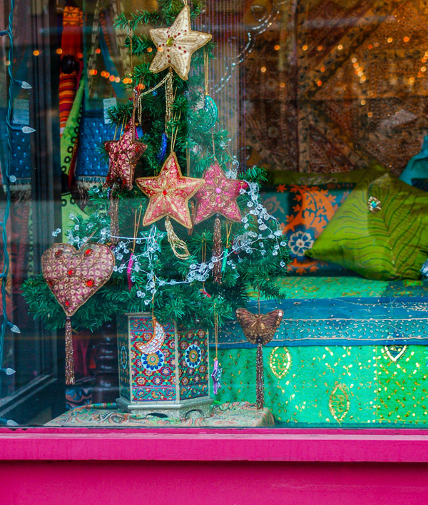brightly coloured Christmas display in the window of a store in Little India
