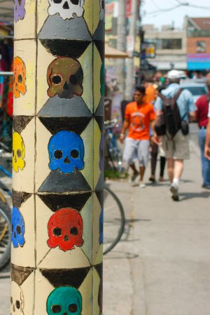 graffiti of abstract facesolourful skulls on a telephone pole