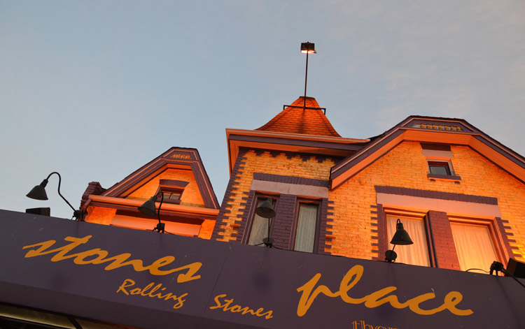 the top part of Stones Place restaurant, a yellow and purple brick building