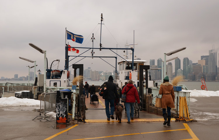 people walking onto the ferry from Wards Island to downtown Toronto in the winter 