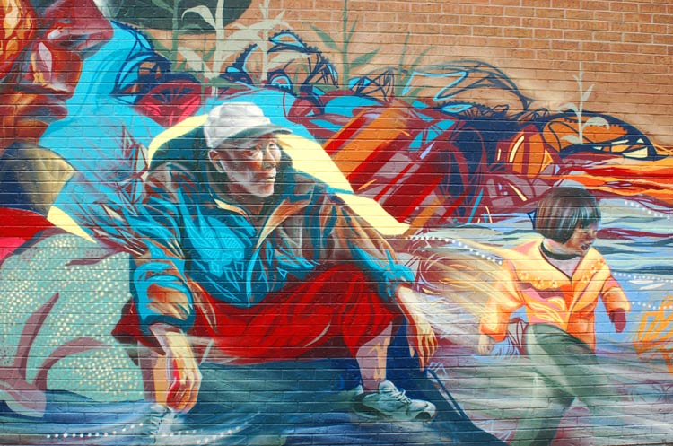part of a mural in Chinatown showing an older man and a young boy