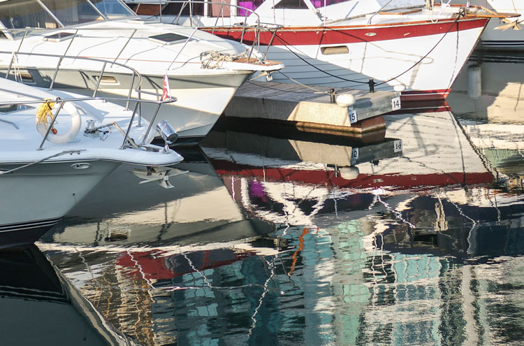 boats moored at Harbourfront and their reflections in the water 