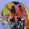 a group of people wearing orange Tshirts pose in front of the Toronto 3D sign at Nathan Phillips Square