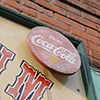 an old wooden coca cola sign on the front of a store