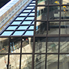 reflections in the glass of a downtown office building