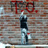 graffiti of a child painting the words I Love T.O. on a red brick wall 