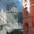 new part of the Royal Ontario Museum beside an older red stone building 