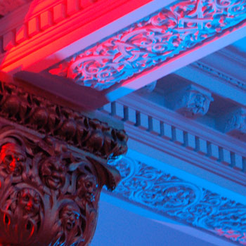  pink, red and blue lights shining on a ceiling