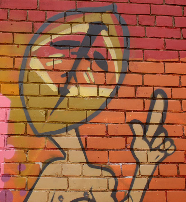 picture of an African mask painted on a brick wall