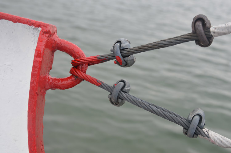 metal cables on the Ward island ferry, attached to the boat by a bright red ring