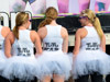 woman wearing white tutus pose for a picture pre-race.  
