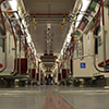 view from floor level of an empty new TTC subway car, looking down the length of the train.