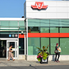 a view of the exterior of the newly renovated Pape Station, taken from across the street