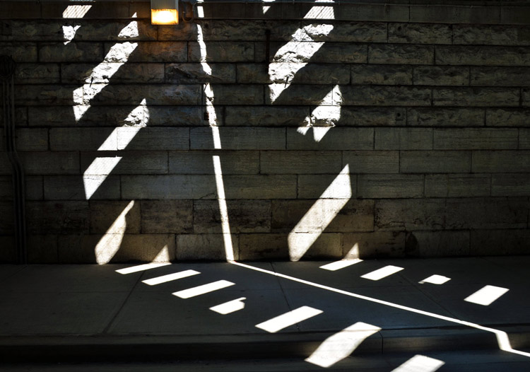 patterns of light and shadow on the wall of the tunnel under railway bridge at Dufferin and Queen St. West