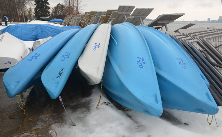 small blue boats stored upside down for the winter 