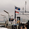 people walking onto the ferry from Wards Island to downtown Toronto in the winter, at ferry dock 