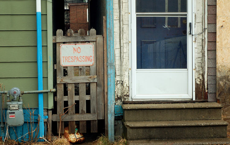 old door that is being held closed with a loop of wired